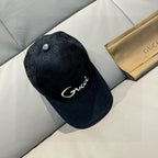 Black GG monogram baseball cap with white logo and small top button.