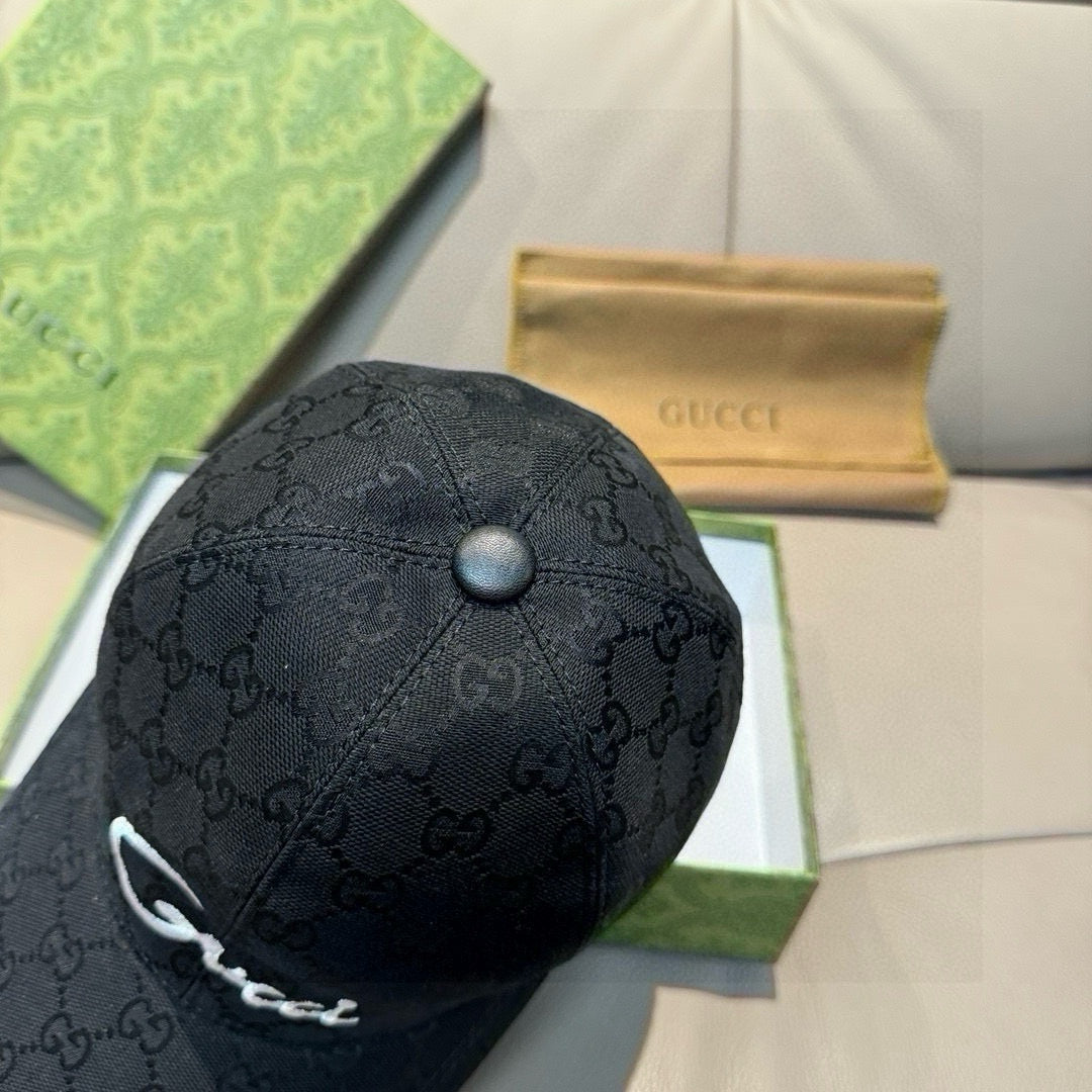 Black GG monogram baseball cap top view with round button detail.