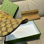 Gucci monogram cap visor close-up with dark fabric edge trim