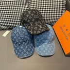 Two baseball caps: black and blue denim with monogram pattern, curved brims