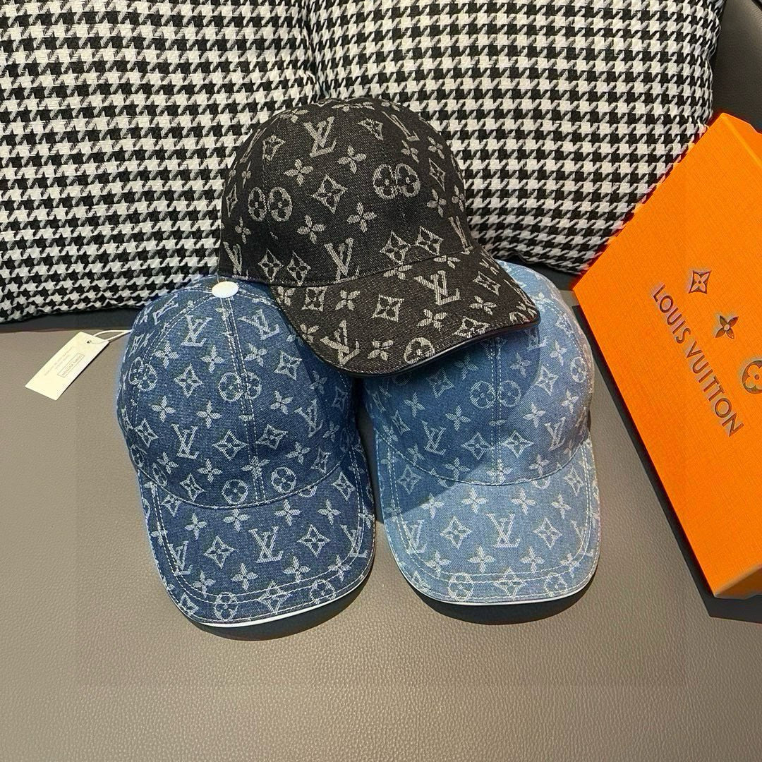 Two baseball caps: black and blue denim with monogram pattern, curved brims