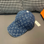 Louis Vuitton denim monogram cap in blue with white logos, top button and curved brim.