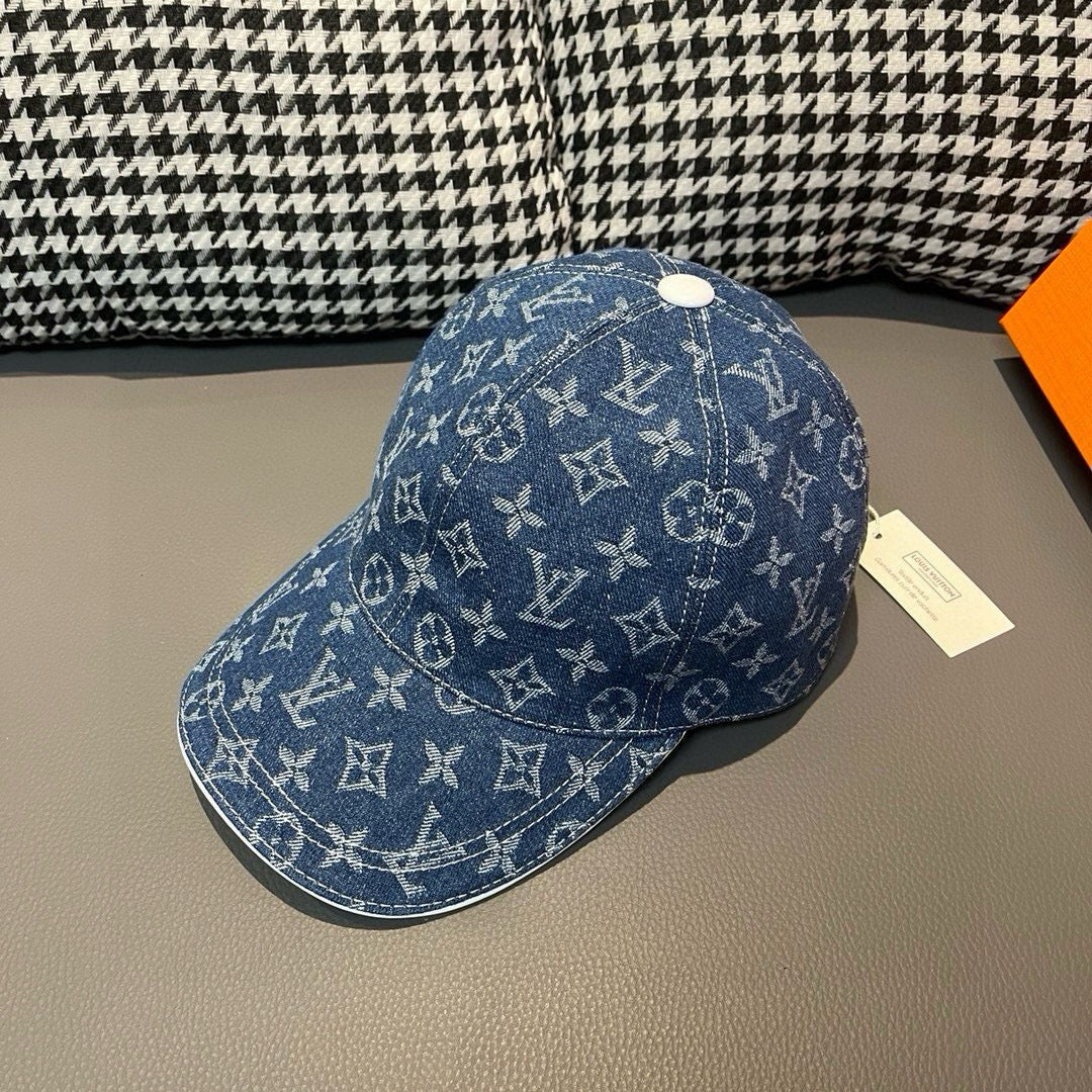 Louis Vuitton denim monogram cap in blue with white logos, top button and curved brim.