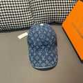 Louis Vuitton denim monogram cap in blue with white pattern, curved brim.