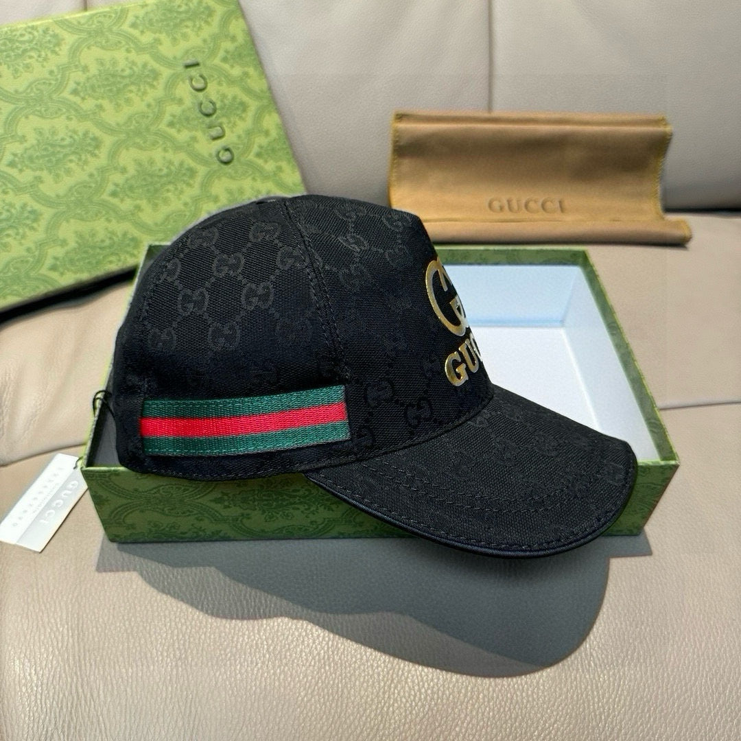 Black Gucci baseball cap with GG monogram and red-green stripe band on brim.