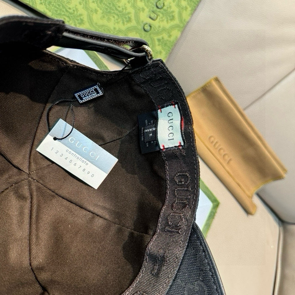 Black Gucci cap interior view with adjustable strap and fabric branding tag