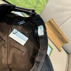Black Gucci cap interior view with adjustable strap and fabric branding tag