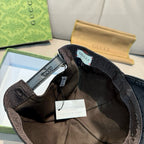 Black Gucci cap interior with adjustable strap and hang tag in gift box