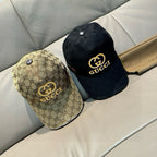 Pair of Gucci caps: black GG monogram cap and beige GG monogram cap with gold logo