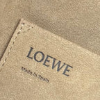 Loewe leather bag label on beige lining, showing LOEWE and Made in Spain.