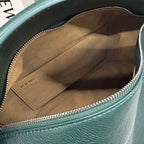 Teal leather bag interior with fabric lining and zippered top opening.