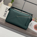 Teal leather satchel bag with zippered front pocket, top handle, and adjustable strap.