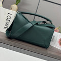 Teal leather shoulder bag with top handle, structured panels, and metal clasp.