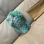 Green GG monogram baseball cap with metal button, curved brim, and side view.
