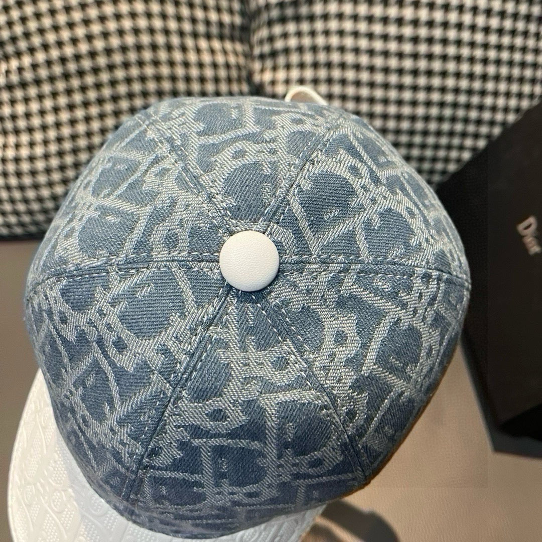 Dior cap top view with blue logo fabric and round white button, seam details