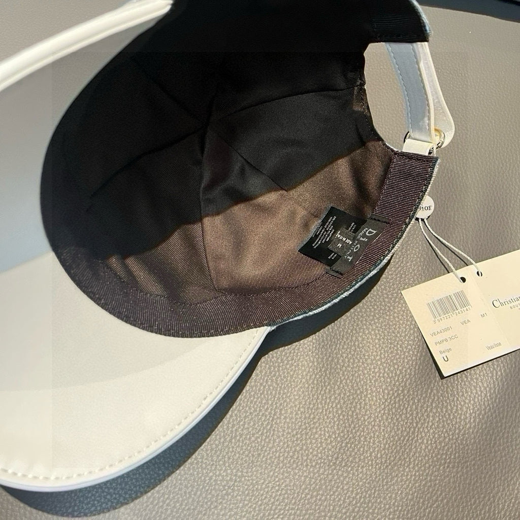 Dior cap interior view with black lining, fabric seam, and hanging size/brand tags