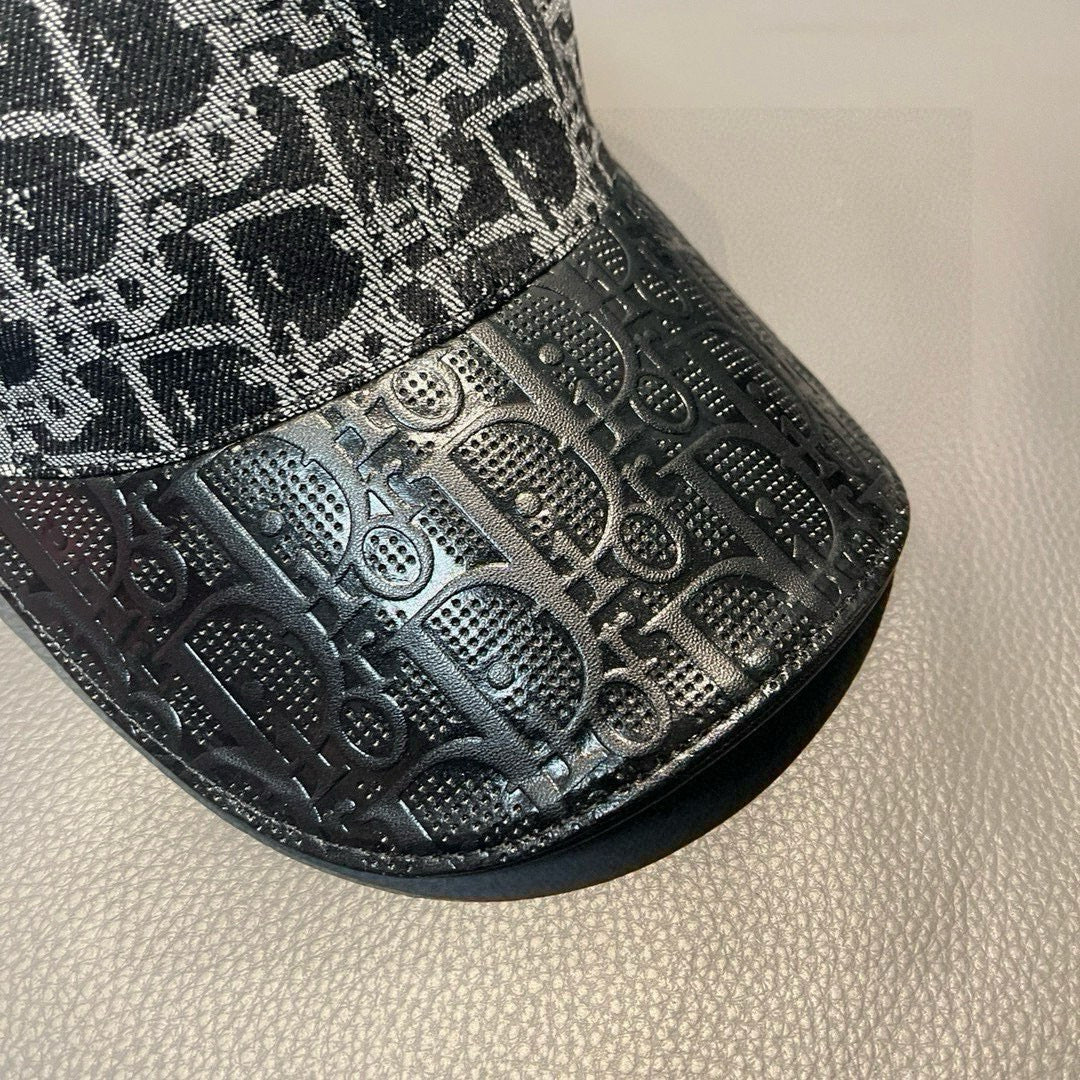 Dior cap brim close-up with embossed monogram and perforated pattern.