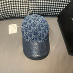 Blue baseball cap with white monogram-style pattern and curved brim; adjustable button top.