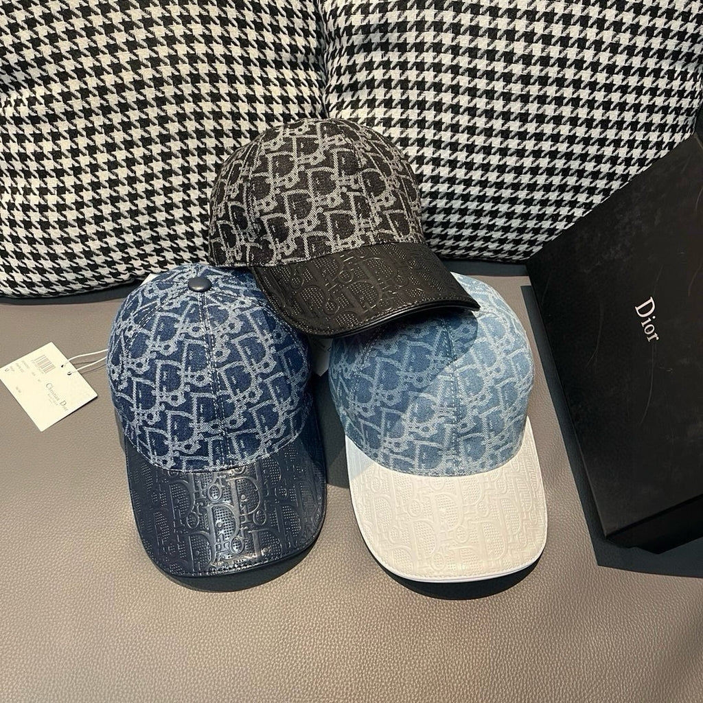 Two caps: blue monogram baseball cap and dark cap with matching monogram pattern brim.