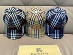 Three plaid baseball caps: navy, beige, and dark multi-color checks