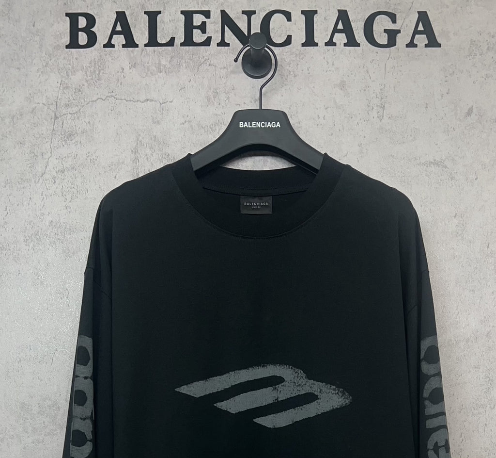 Balenciaga long-sleeve T-shirt, dark front close-up with large “B” style logo
