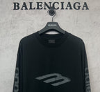 Balenciaga long-sleeve T-shirt, dark front close-up with large “B” style logo