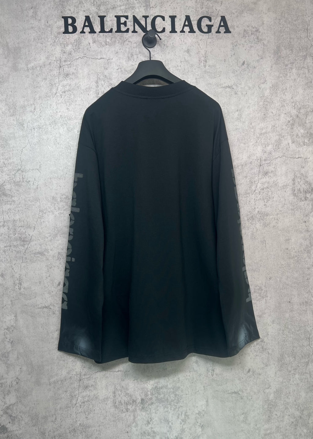 Balenciaga long-sleeve T-shirt, dark back view with logo text on both sleeves