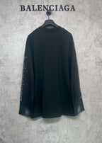 Balenciaga long-sleeve T-shirt, dark back view with logo text on both sleeves