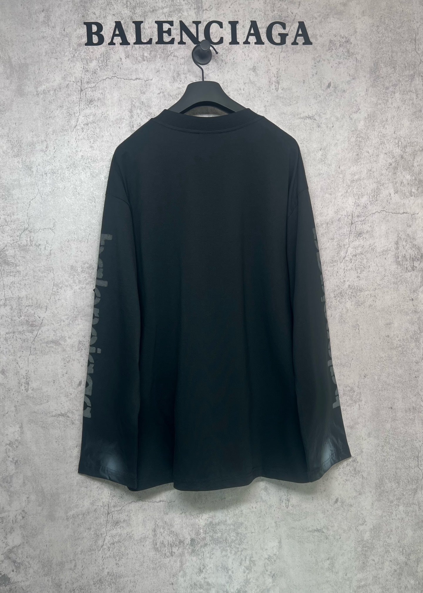 Balenciaga long-sleeve T-shirt, dark back view with logo text on both sleeves