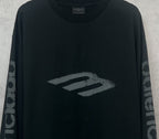 Balenciaga long-sleeve T-shirt, dark front close-up with large “B” style logo graphic