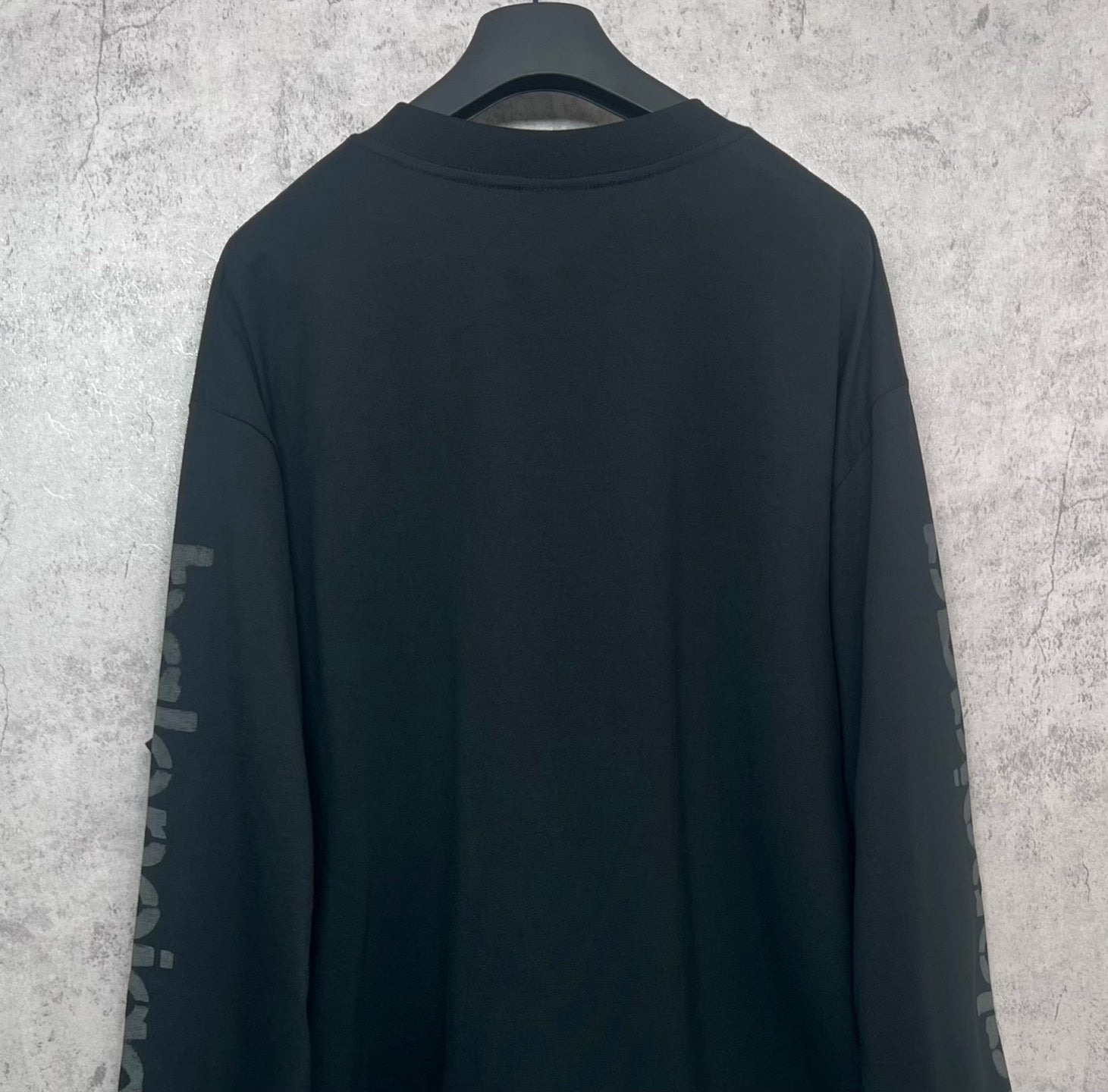 Balenciaga long-sleeve T-shirt, dark back view with sleeve logo text