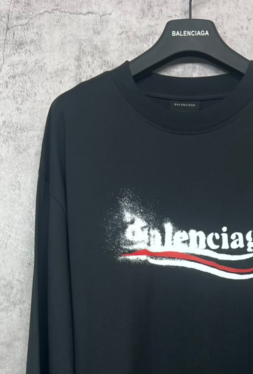 Black crew-neck long-sleeve shirt with Balenciaga logo across chest