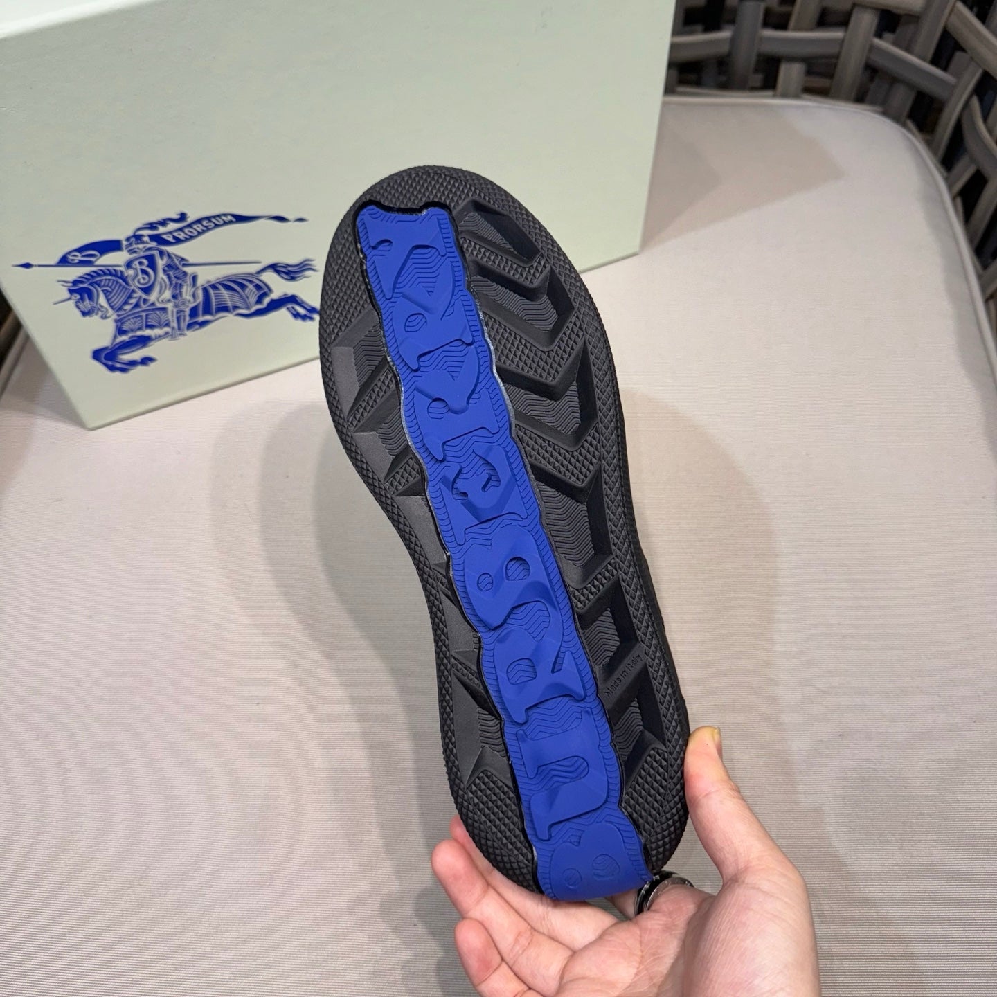 Burberry sneaker outsole with blue tread, bottom view