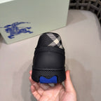 Burberry black sneakers heel with plaid insert and blue logo tab, back view