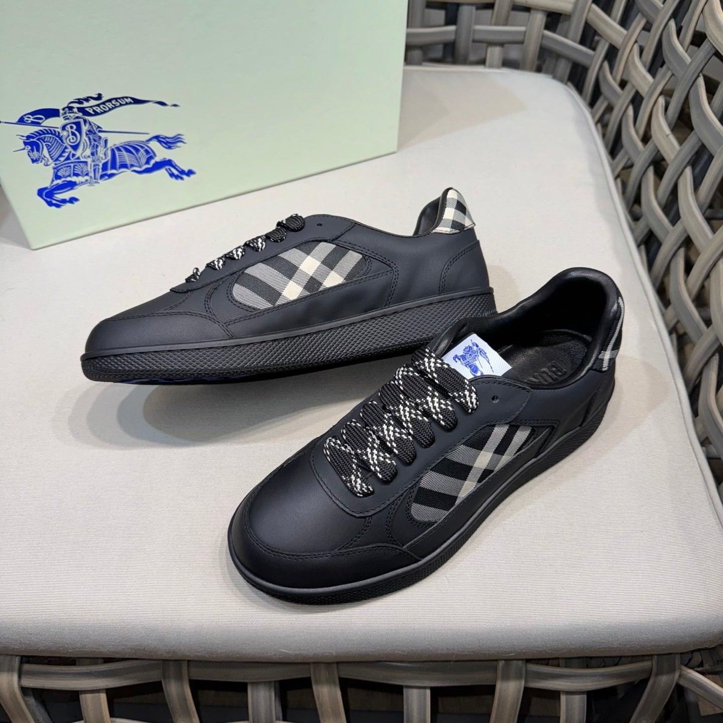 Burberry black sneakers with plaid panel, lace-up front, angled view