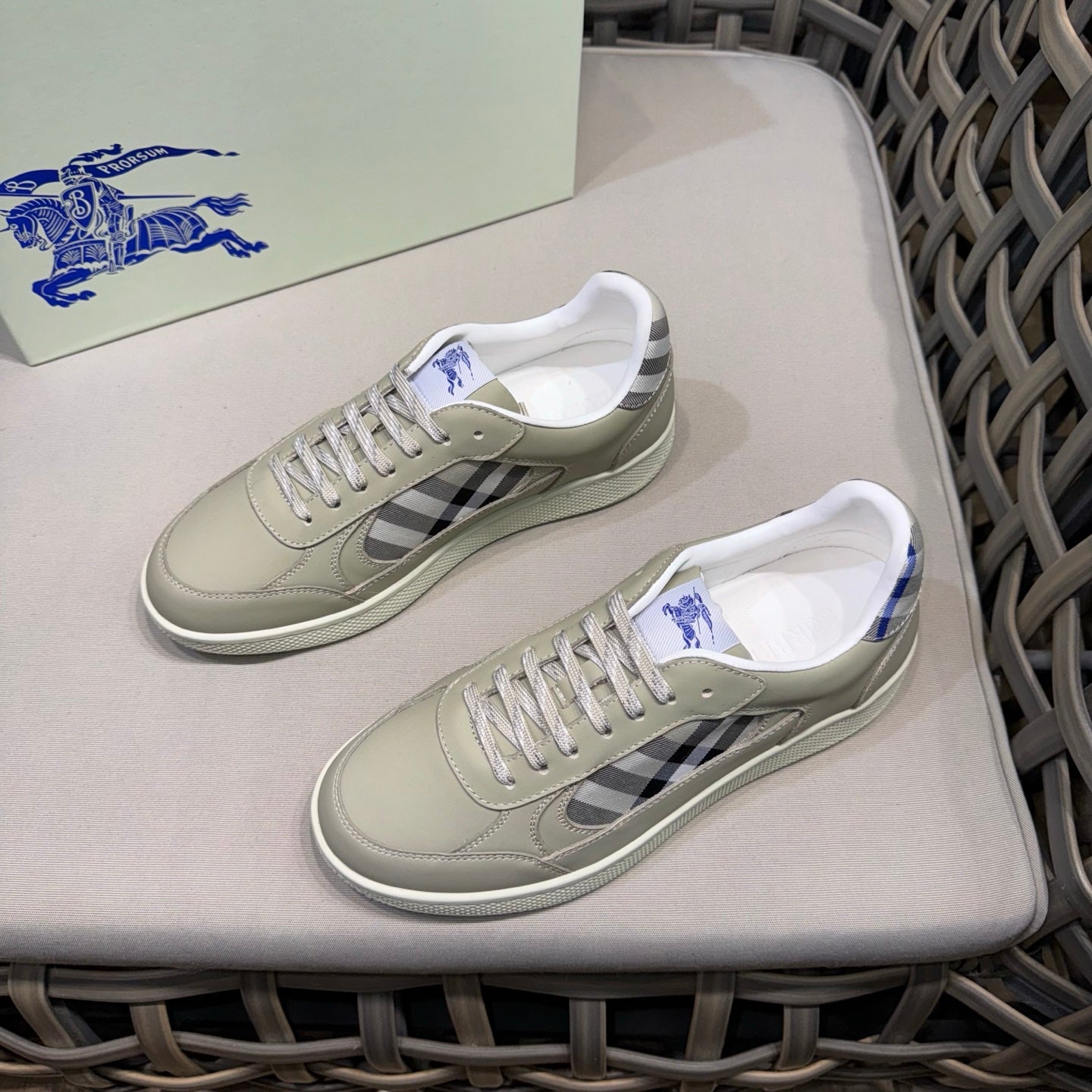 Burberry low-top sneakers showing side profile with beige leather and check detail