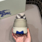 Burberry sneaker close-up on heel, beige heel tab with navy/black check panel