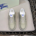 Burberry low-top sneakers in light beige with blue laces and side check panel