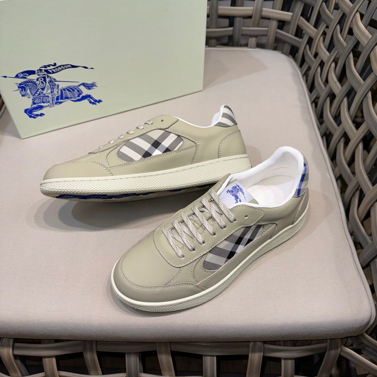 Burberry low-top sneakers pair, beige uppers with navy/black check stripe and white sole