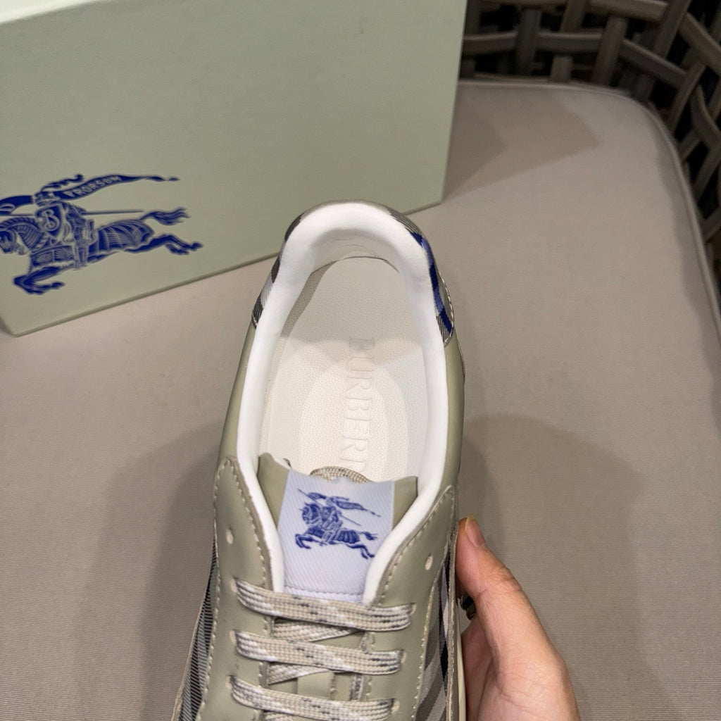 Burberry sneaker close-up at opening, light beige leather with blue logo lining