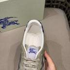 Burberry sneaker close-up at opening, light beige leather with blue logo lining