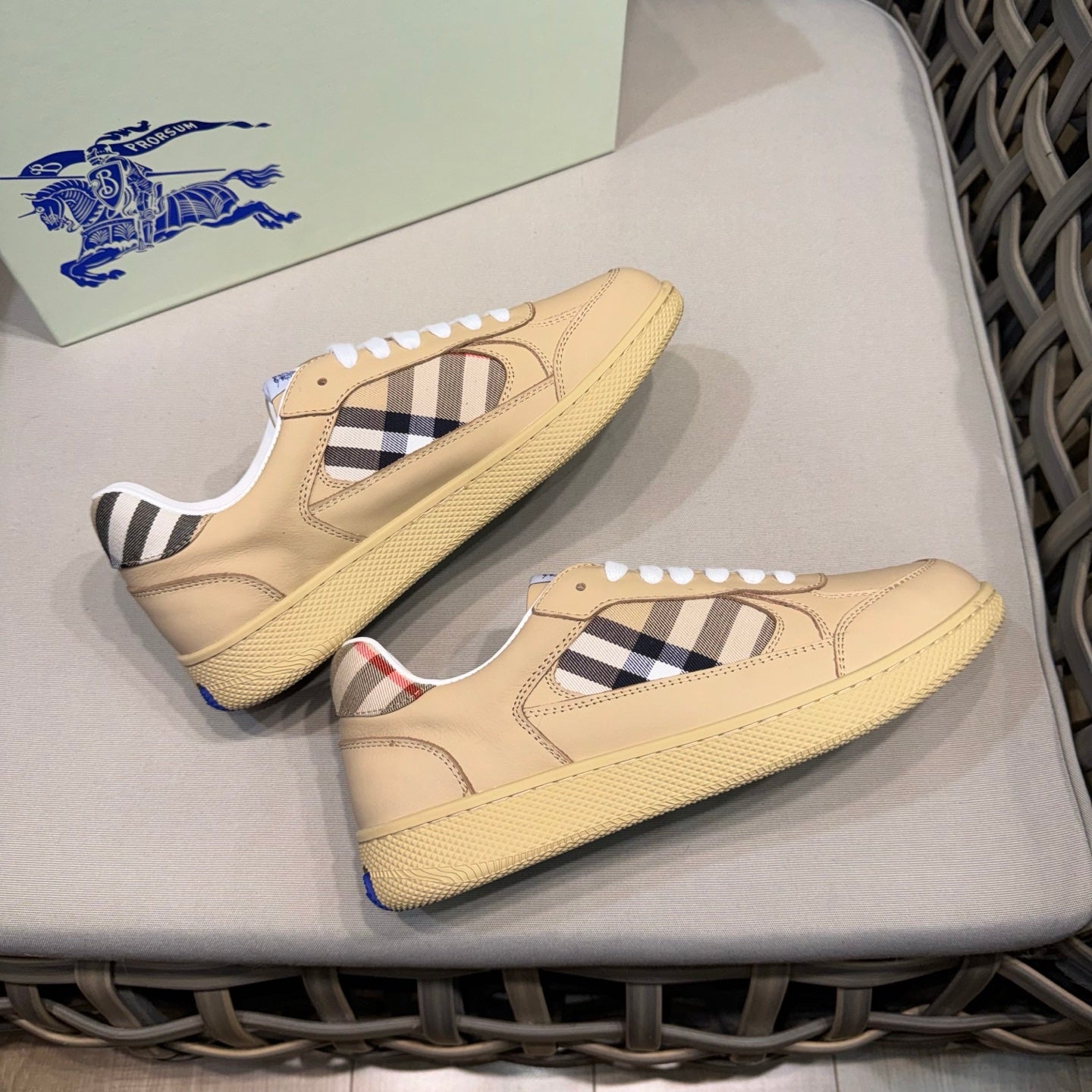 Beige low-top sneakers with white laces and black-and-white check inserts