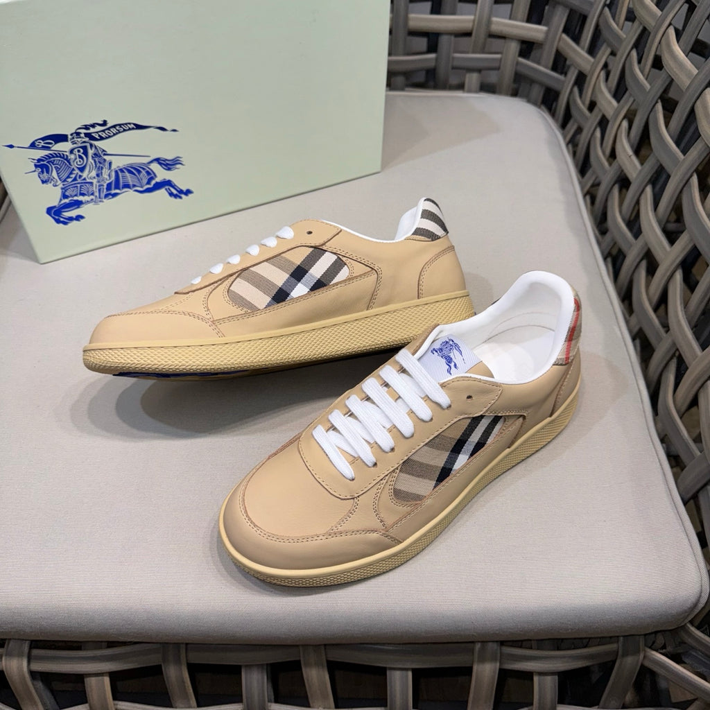 Beige leather sneakers with white laces, black check panel, and textured sole