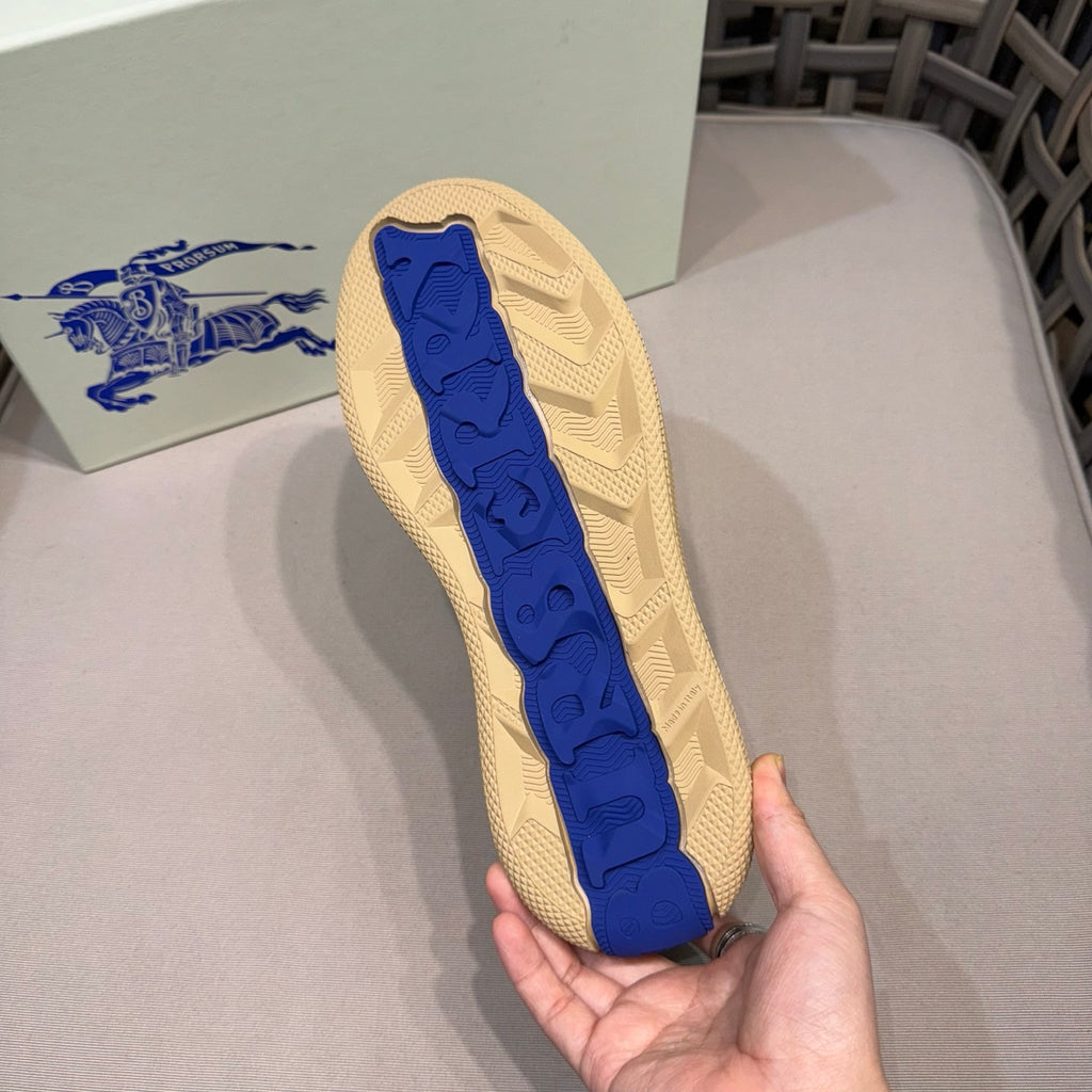 Beige sneaker outsole with blue tread logo