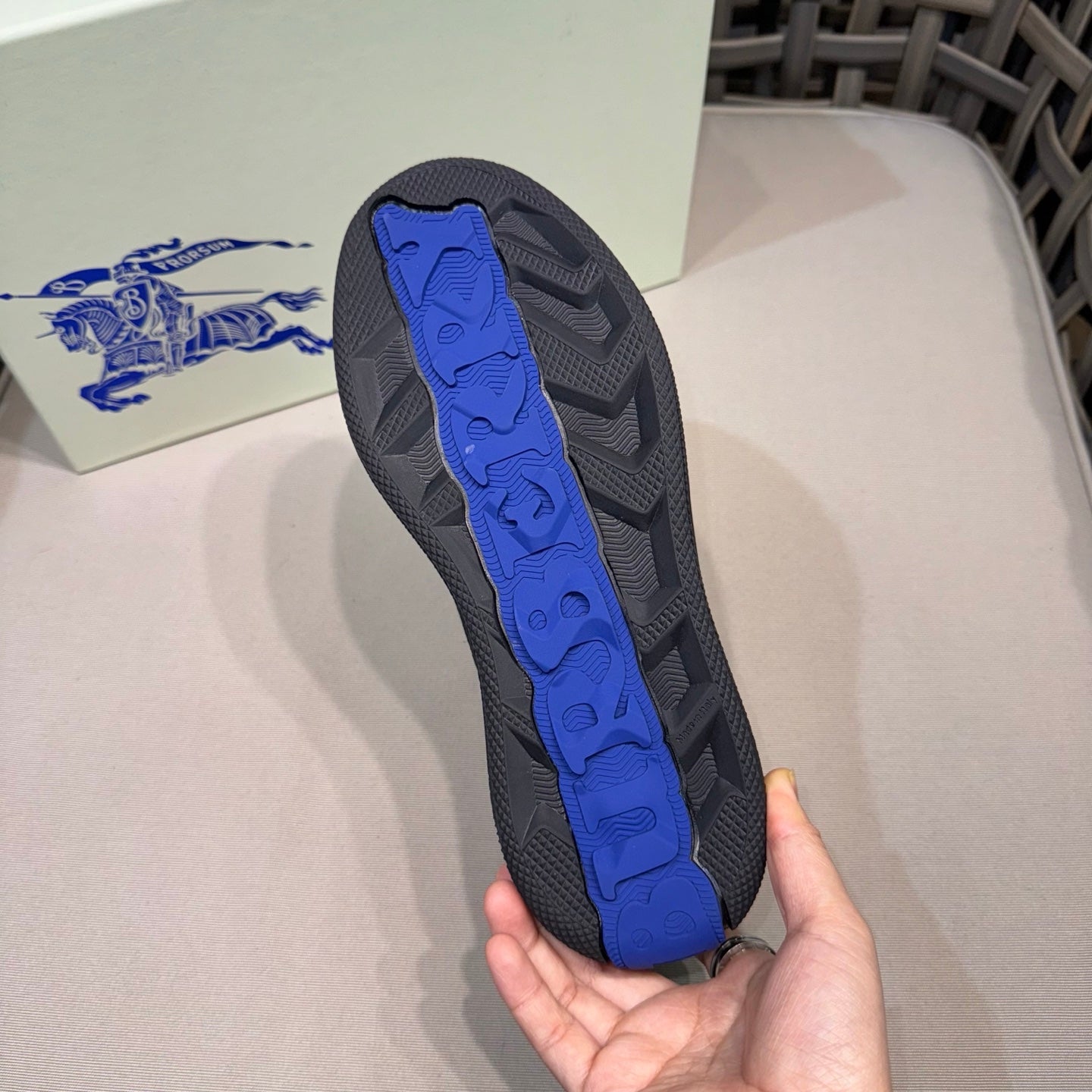 Shoe outsole with blue traction insert and textured tread pattern