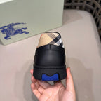 Black low-top sneaker heel with beige check upper and blue tread accent