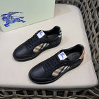 Black low-top sneakers with check-stitch side panels and lace-up design