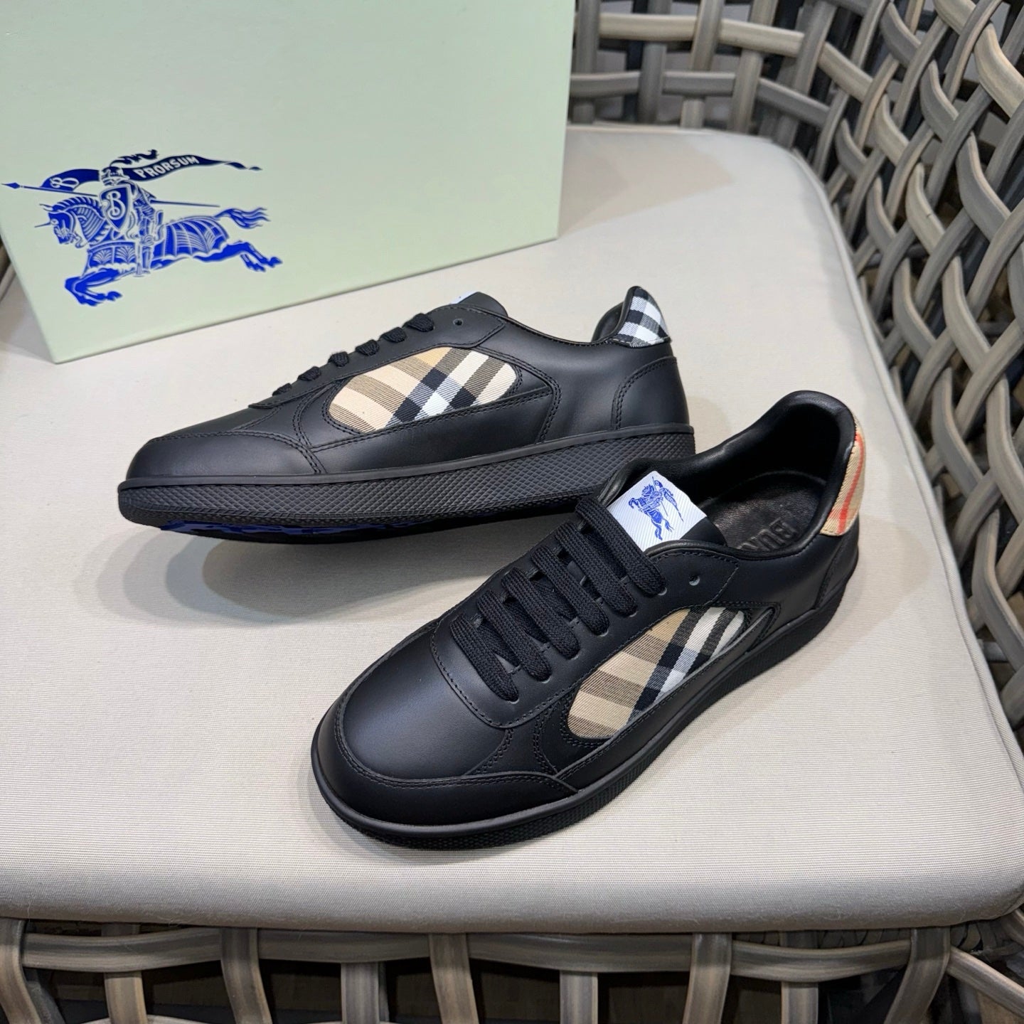 Black lace-up sneakers with beige check quarter panel and blue trim