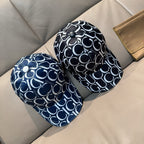 Pair of Gucci baseball caps in navy with white GG monogram patterns, curved brims