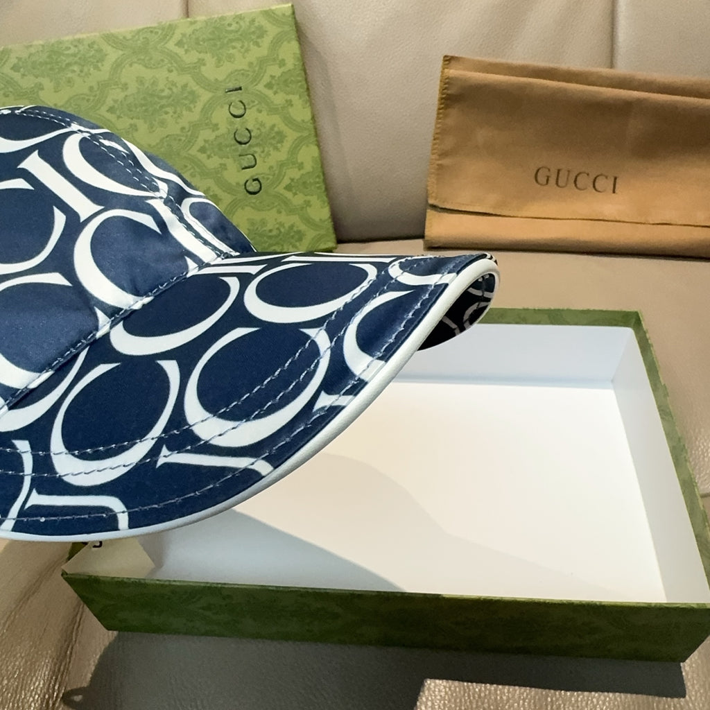 Gucci baseball cap brim close-up with navy and white GG monogram pattern